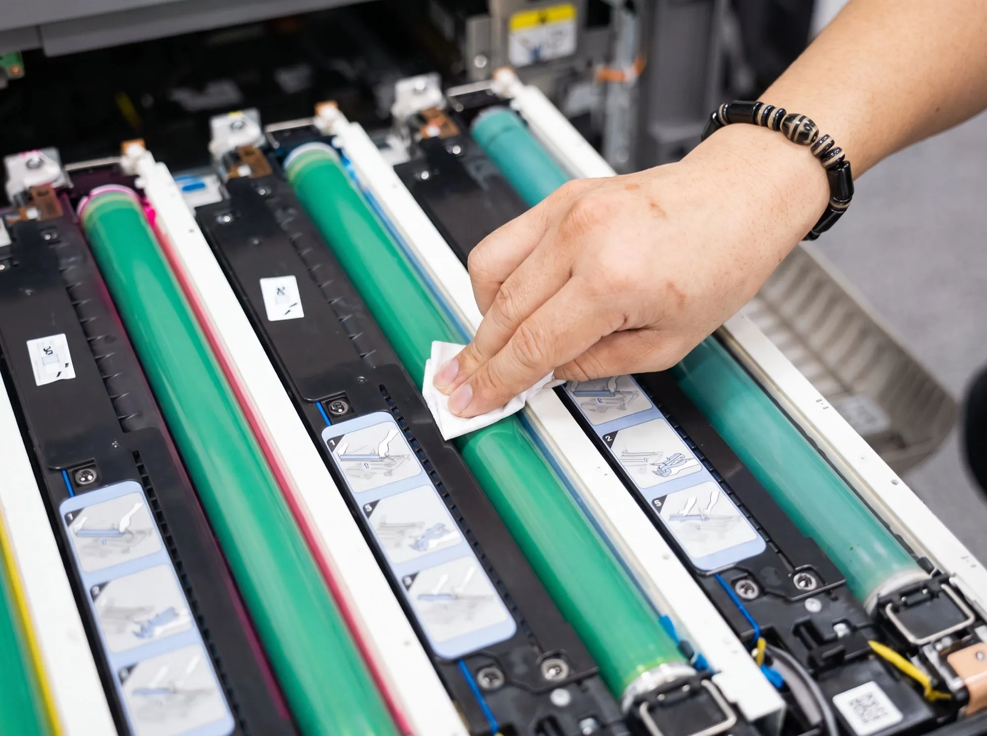 Cleaning the drum units inside a colour copier